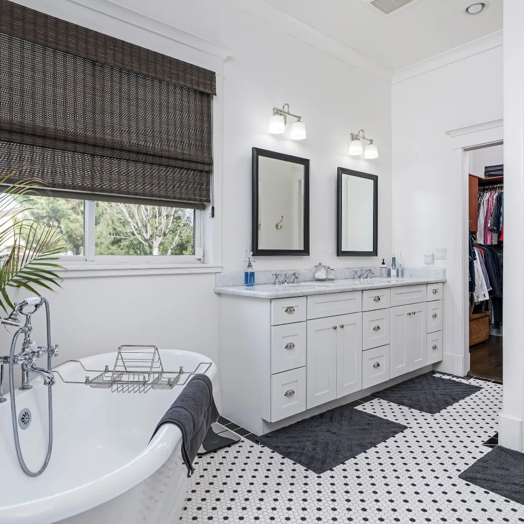 Bright bathroom with a double vanity and freestanding tub