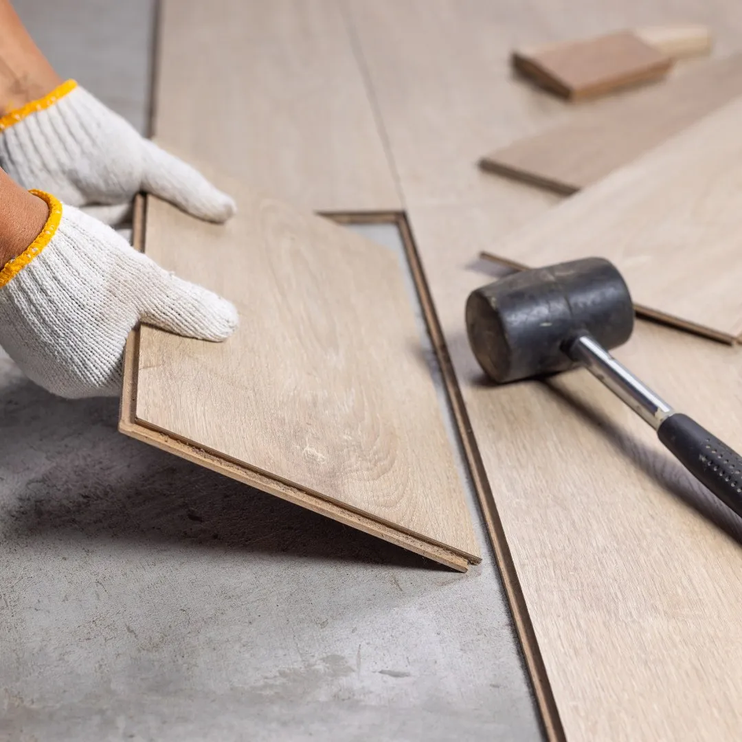 Fitting laminate flooring planks with a mallet