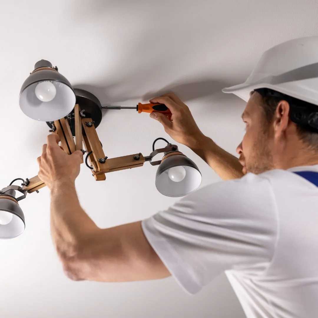 Handyman installing a ceiling light fixture