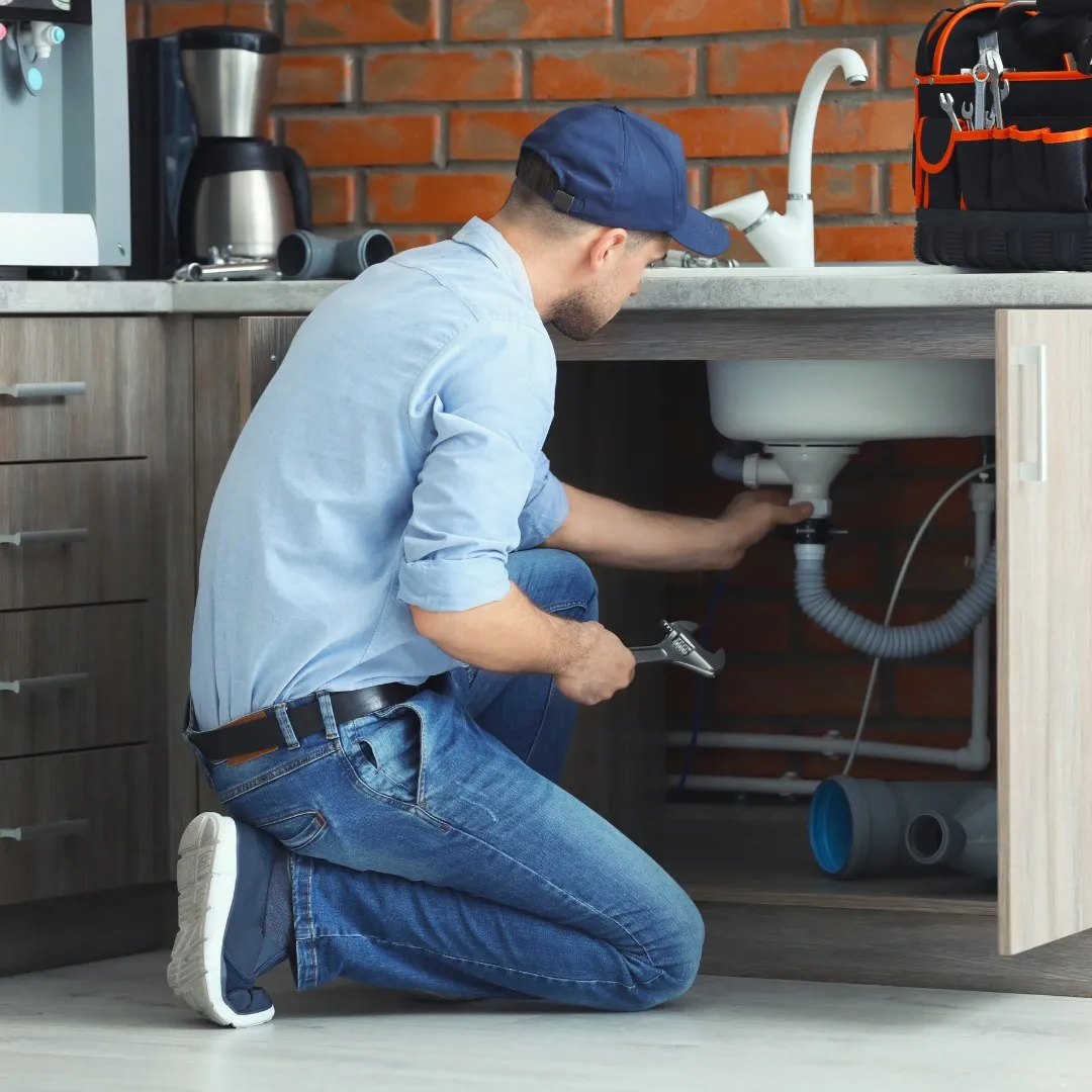 Repairing plumbing under a kitchen sink